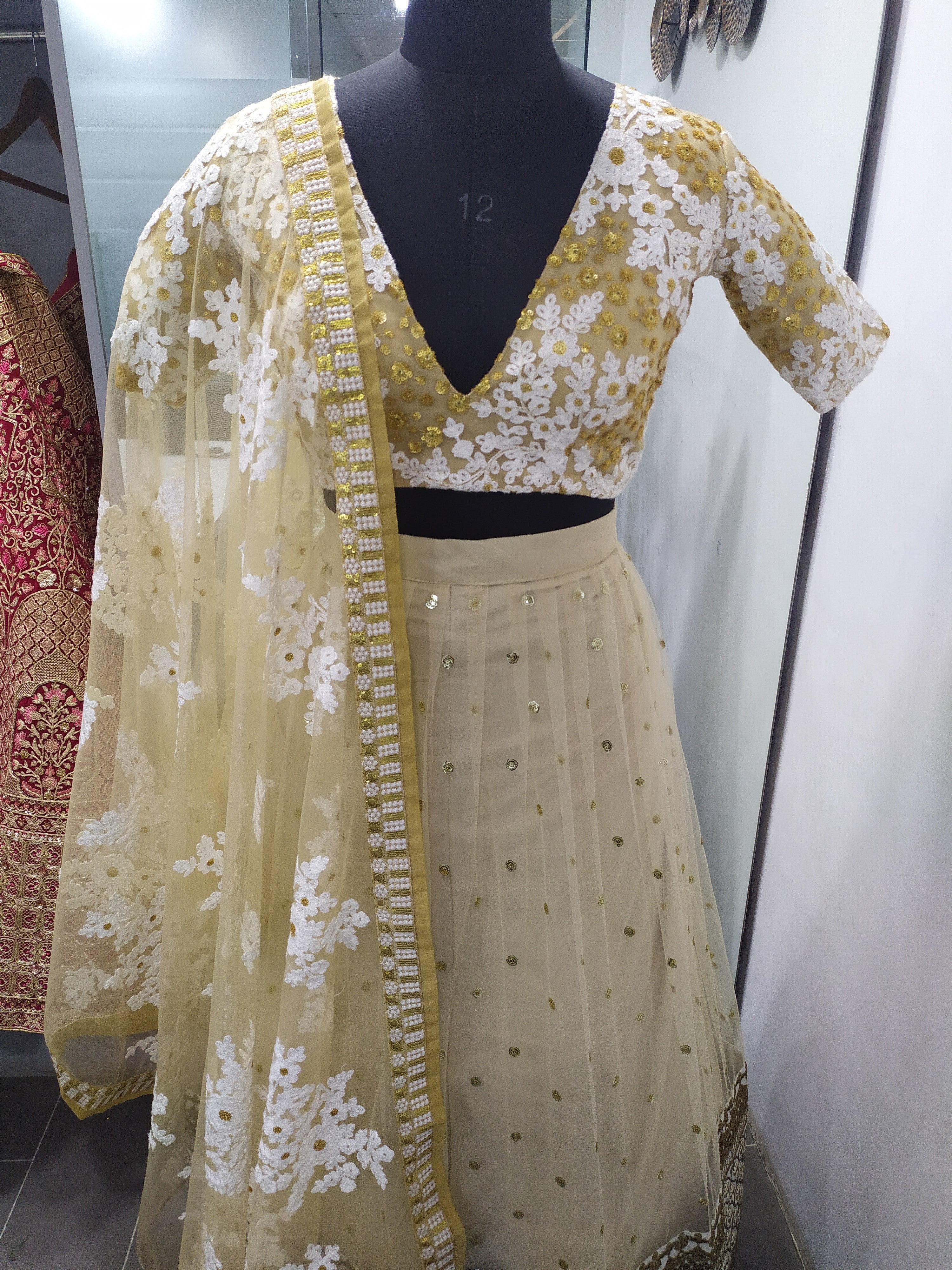 Cream Lehenga Choli In Soft Net With Zari Work