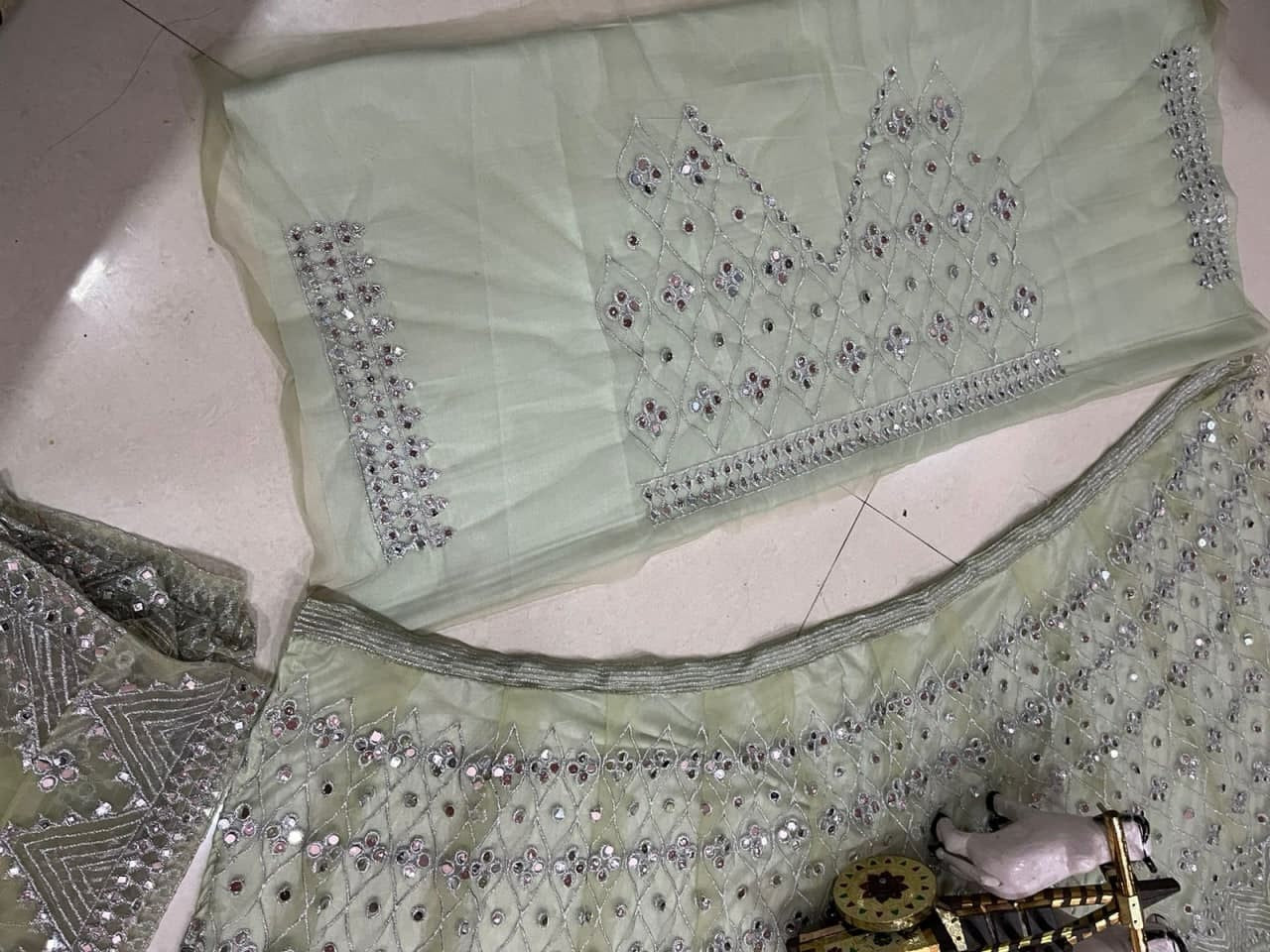 Light Pista Lehenga Choli In Butterfly Mono Net With Real Mirror Embroidery Work