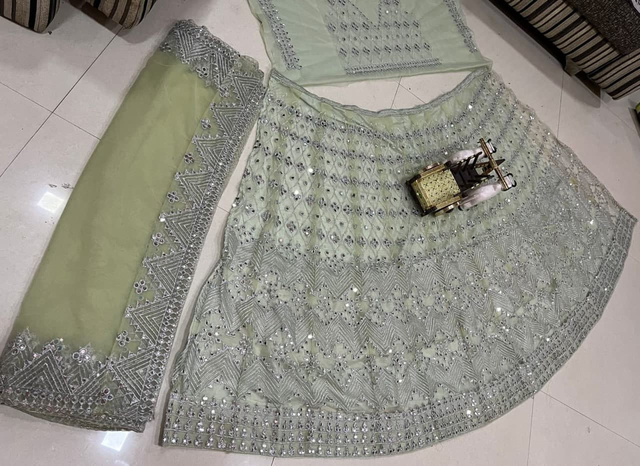 Light Pista Lehenga Choli In Butterfly Mono Net With Real Mirror Embroidery Work