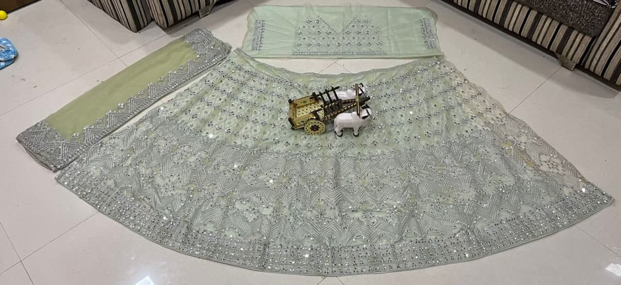 Light Pista Lehenga Choli In Butterfly Mono Net With Real Mirror Embroidery Work