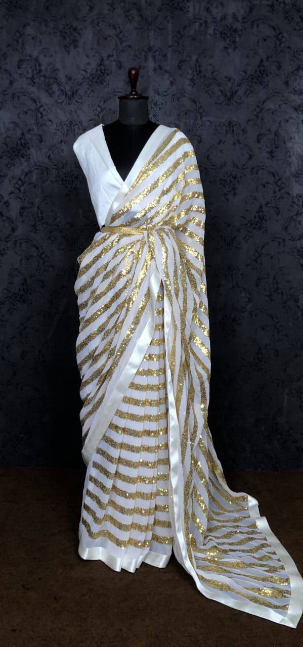 White Saree In Blooming Georgette With Golden Heavy Sequence Work