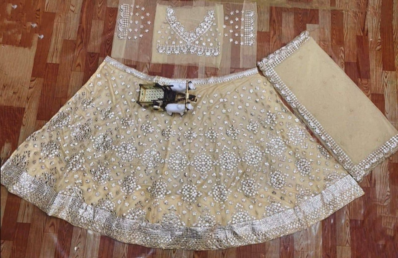 Cream Lehenga Choli In Soft Mono Net With Foil Mirror Embroidery Work